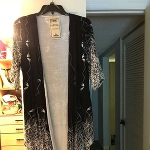 Sweater of lightweight material.  Fit like a small